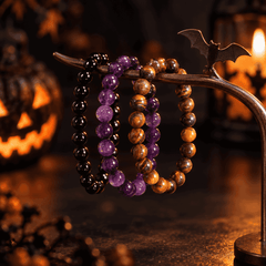 Three separate stretch bracelets displayed together in a Halloween setting