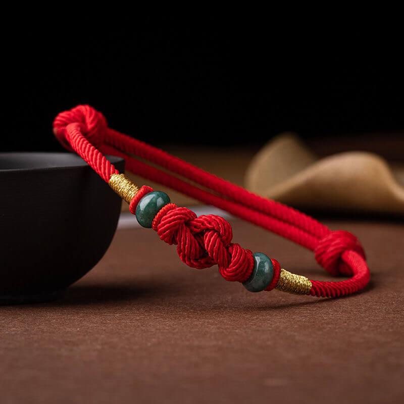 Red String and Lucky Jade Bead Bracelet, a meaningful charm bracelet for good luck, protection, and positive energy.