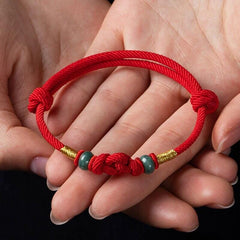 Red String and Lucky Jade Bead Bracelet, a meaningful charm bracelet for good luck, protection, and positive energy.