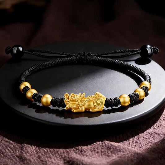 Cerapoet black cord bracelet with a gold-tone Pixiu charm