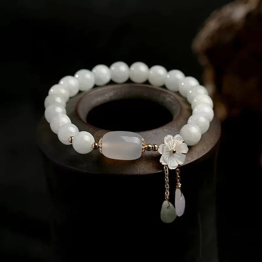 Handcrafted white jade energy bracelet with flower charm and oval bead