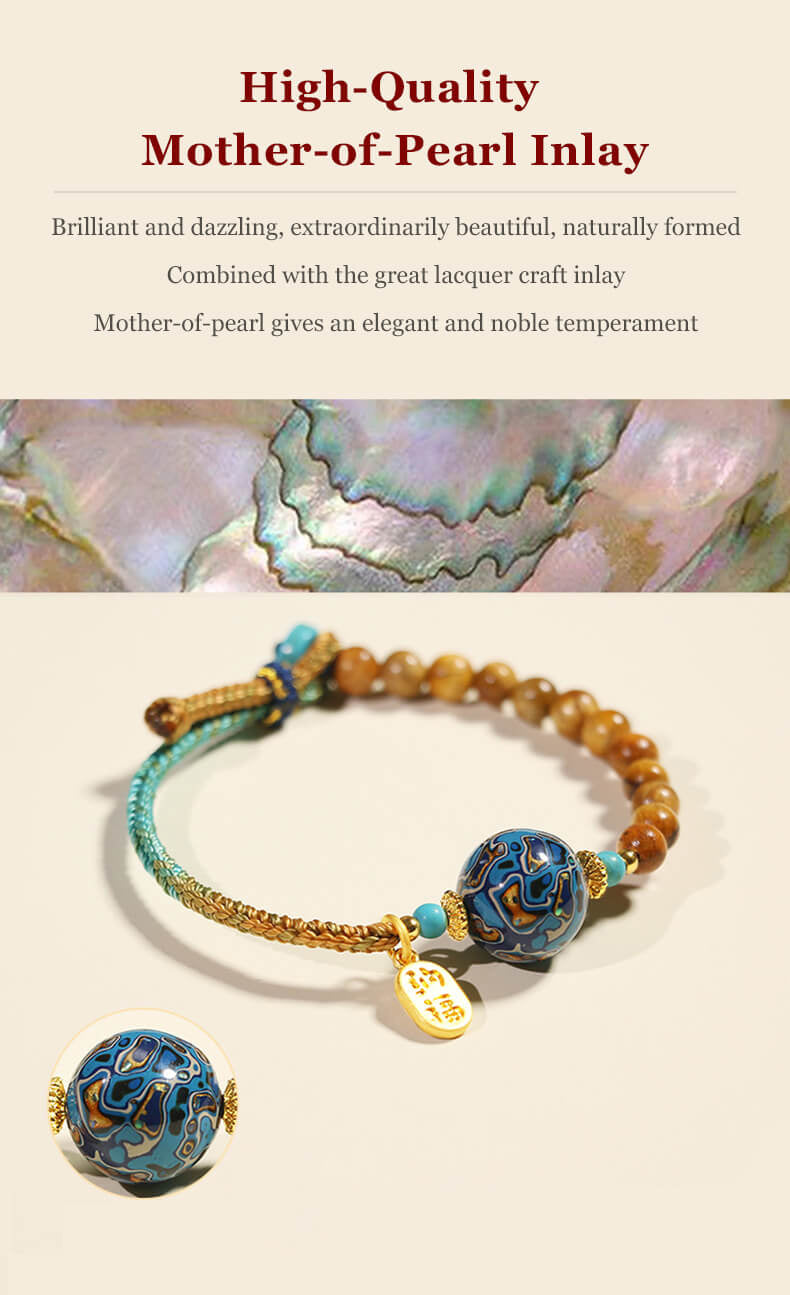 Handcrafted energy bracelet with brown beads, blue patterned stone, and gold charm.