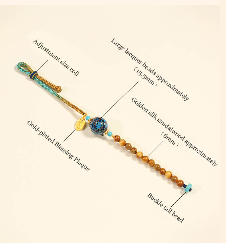 Handcrafted energy bracelet featuring blue lacquer beads, sandalwood beads, and a gold blessing plaque.