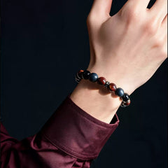Red tiger’s eye, obsidian and lava stone bracelet worn with a burgundy shirt