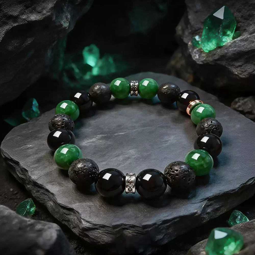 Green and black 10 mm beaded bracelet displayed on a dark stone surface