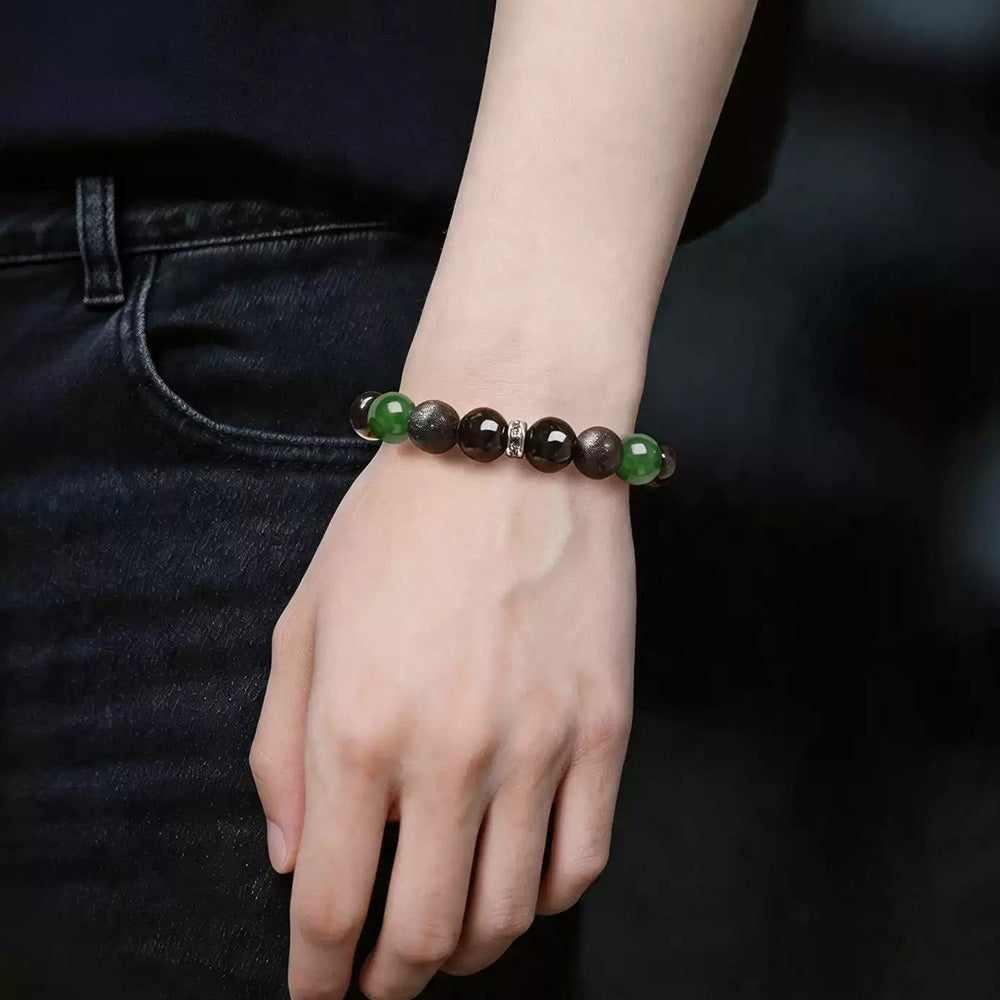 Green chalcedony, obsidian and lava bead stretch bracelet worn with black clothing