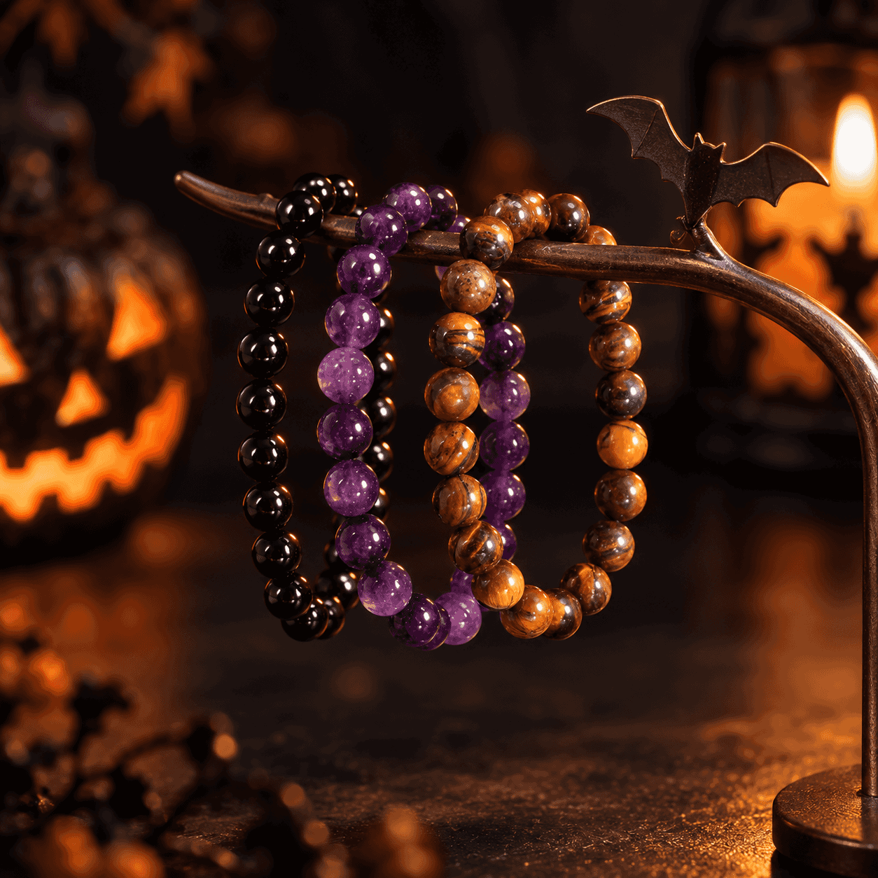 Three separate stretch bracelets displayed together in a Halloween setting