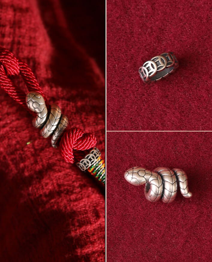 Handcrafted silver snake charms on a red energy bracelet and as a ring