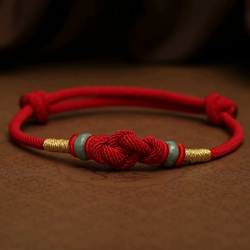 Red String and Lucky Jade Bead Bracelet, a meaningful charm bracelet for good luck, protection, and positive energy.