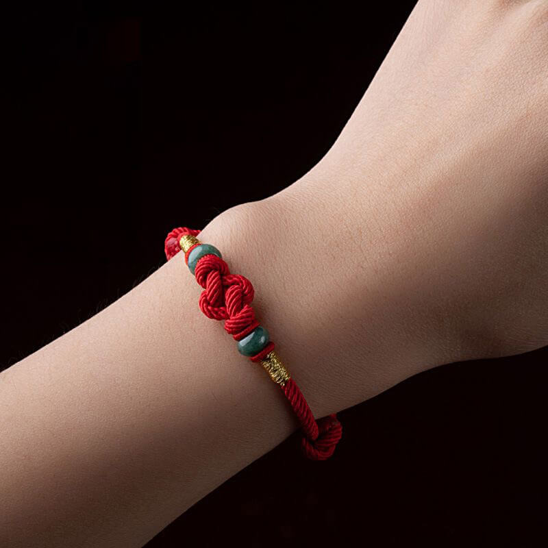 Red String and Lucky Jade Bead Bracelet, a meaningful charm bracelet for good luck, protection, and positive energy.