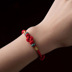 Red String and Lucky Jade Bead Bracelet, a meaningful charm bracelet for good luck, protection, and positive energy.