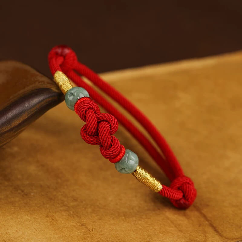 Red String and Lucky Jade Bead Bracelet, a meaningful charm bracelet for good luck, protection, and positive energy.