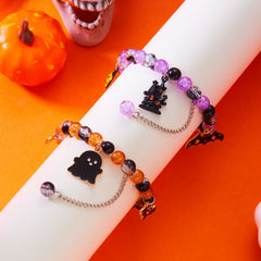 Purple haunted house and orange ghost Halloween charm bracelets displayed together