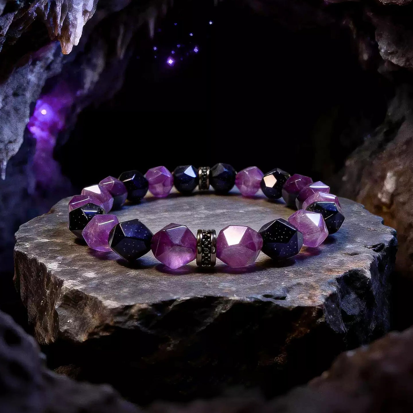 Faceted purple amethyst and midnight-blue goldstone bracelet with black spacers on a stone display