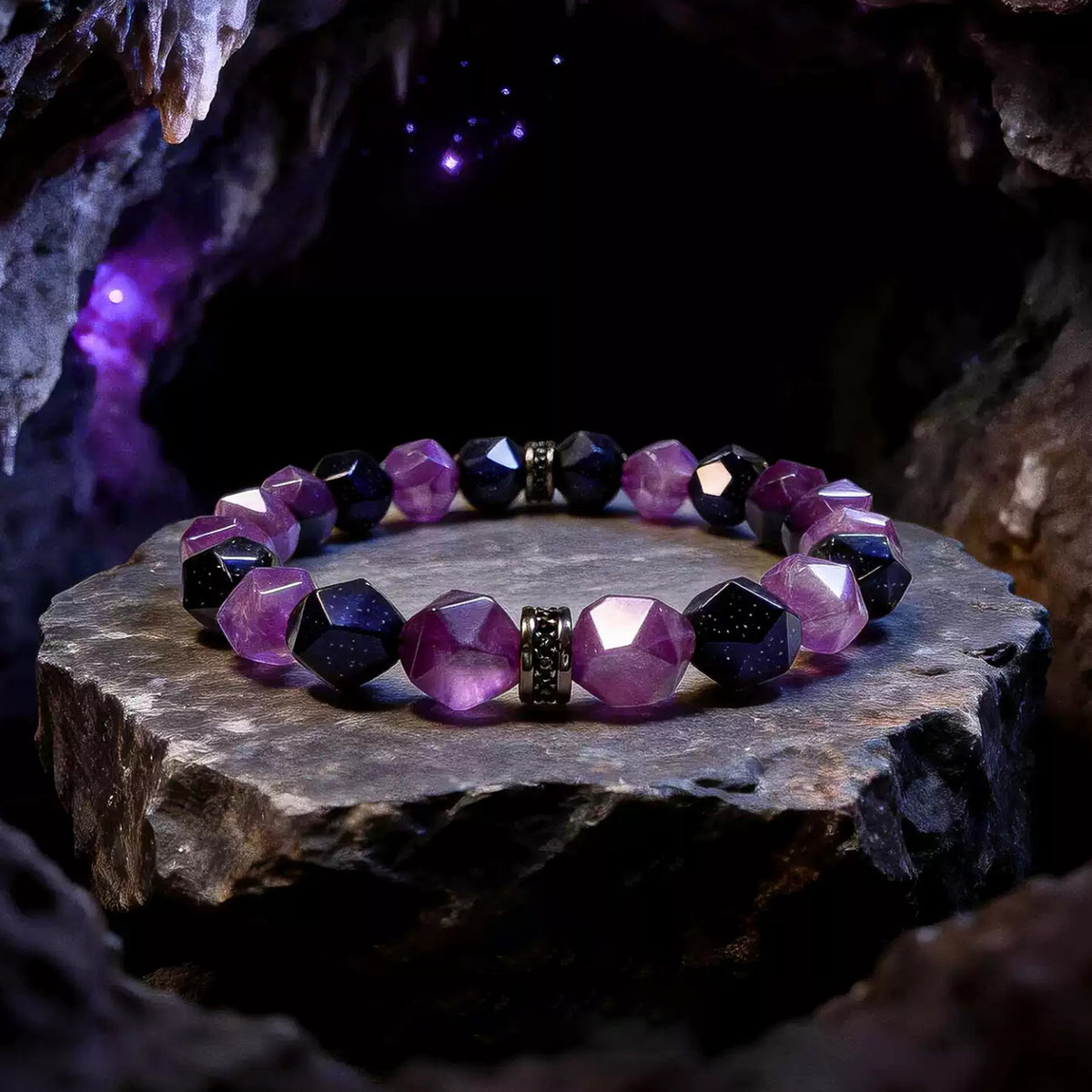 Faceted purple amethyst and midnight-blue goldstone bracelet with black spacers on a stone display
