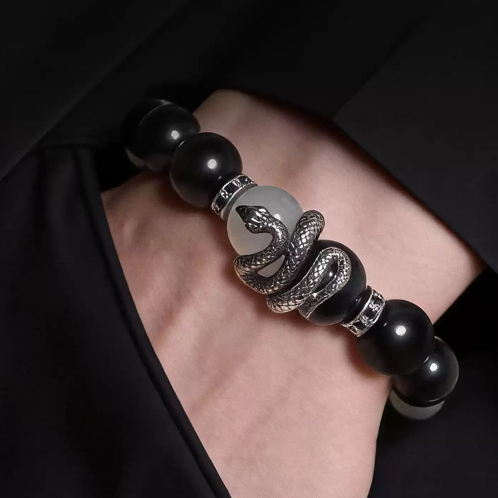 Close-up of a silver-tone coiled snake centerpiece between black and white beads