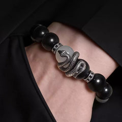 Close-up of a silver-tone coiled snake centerpiece between black and white beads